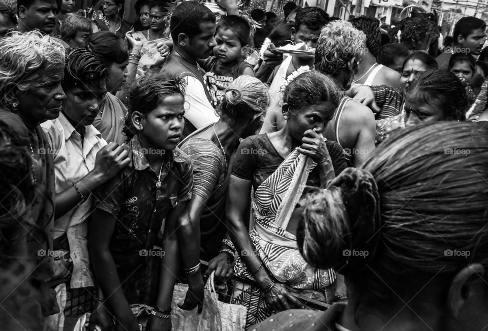 Hunger and poverty. A group of poor and hungry women waiting outside a local community temple to collect the food offered by the devotees