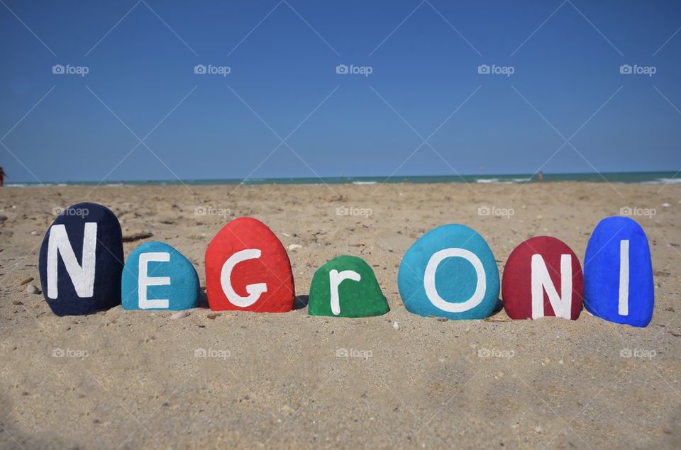 Negroni cocktail word on colored stones