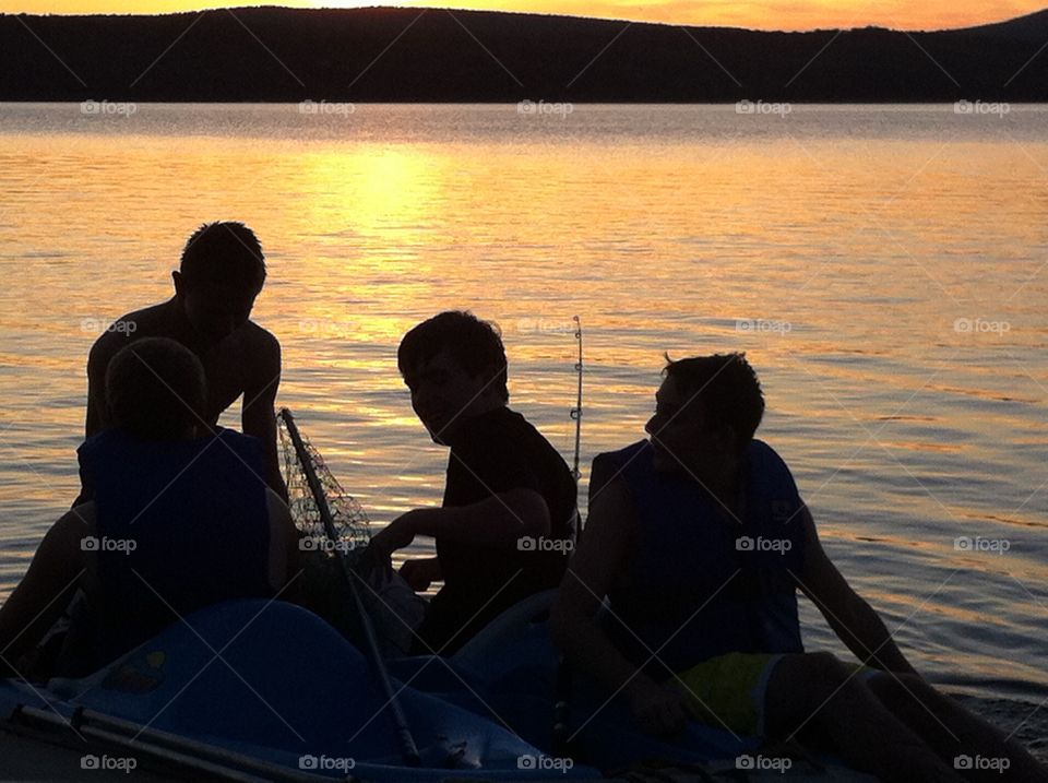 Youth Teen boys Fishing on Lake at sunset. Youth Teen boys Fishing on Lake at sunset