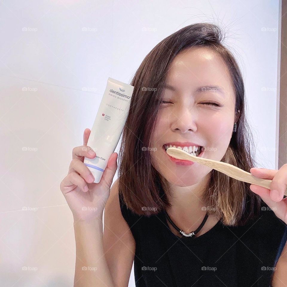 Asian woman with Swiss brand toothpaste 