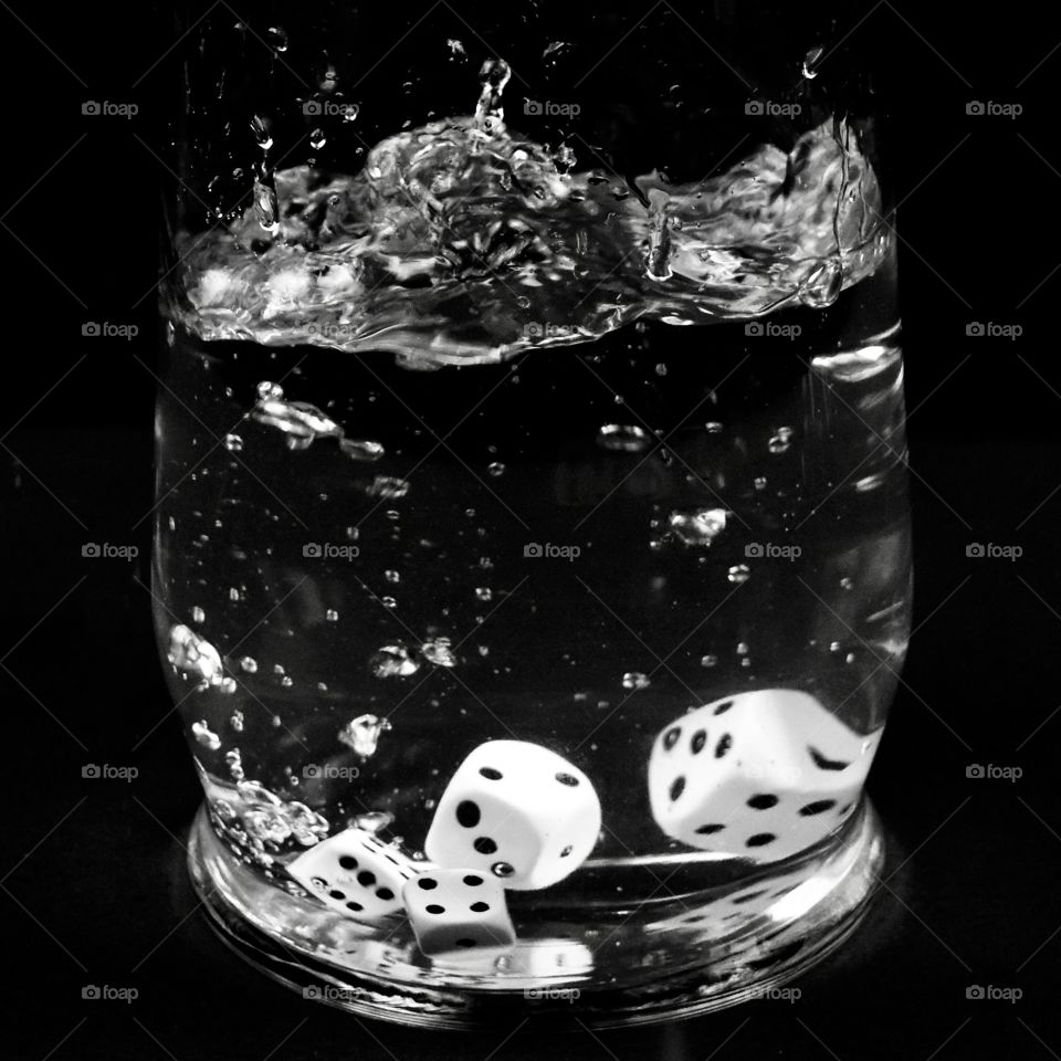 Black and white dice water splash with black background 