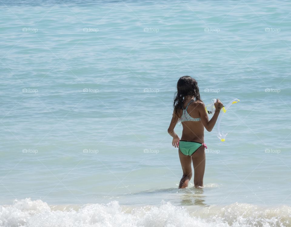 A cute girl do her hobby in the beautiful sea