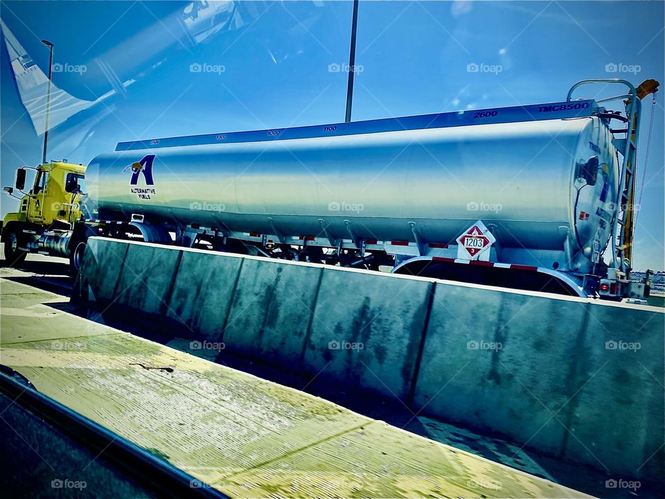 A gigantic shiny silver aluminum truck of some kind passing us by as we are being chauffeured around New York City’s outer boroughs from Queens to Brooklyn or vice versa. 2022. Hypnotic Productions