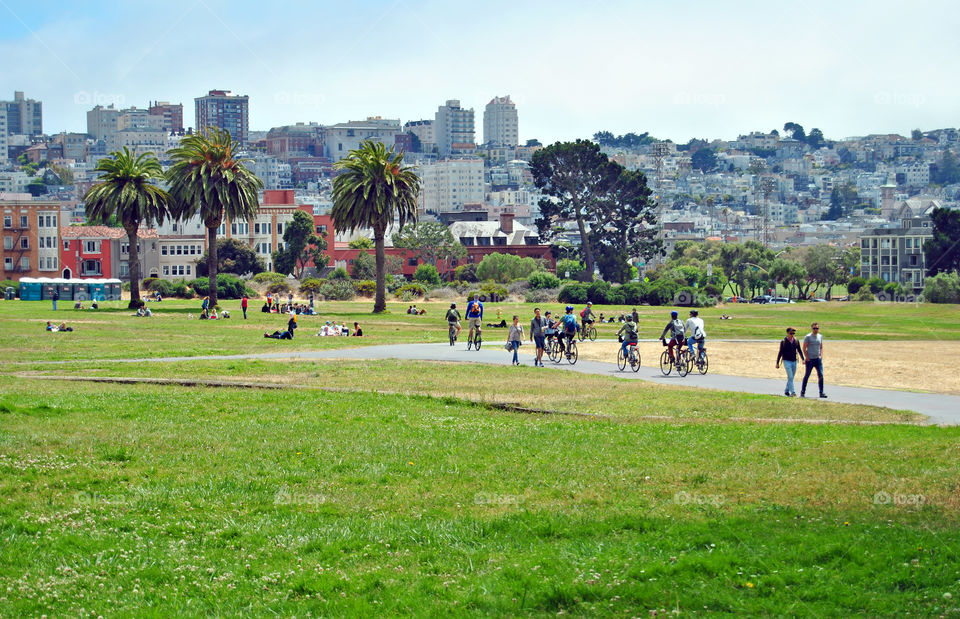 people biking, jogging, running, walking, chilling, having a picnic, at Fort Mason, San Francisco, city view