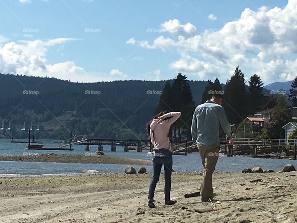 Asian Couple walking on the beach