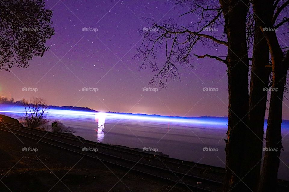 A barge shines bright on the Mississippi river