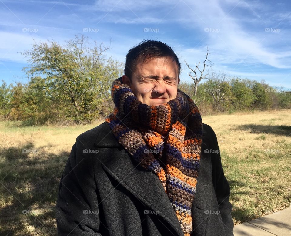 Sun in his eyes while modeling a scarf