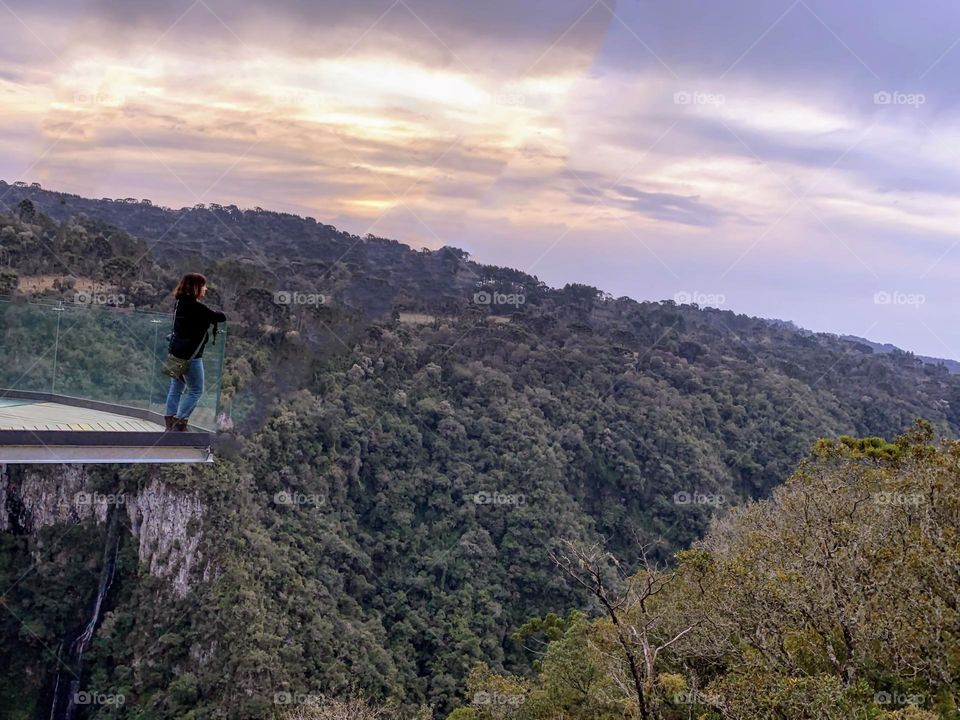 Woman admiring the landscape of the canyons at Sunset 