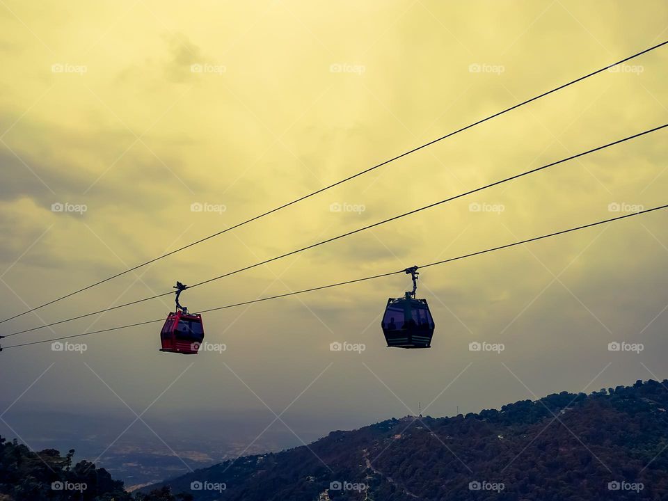 Two cable cars in the mountain at sunset
