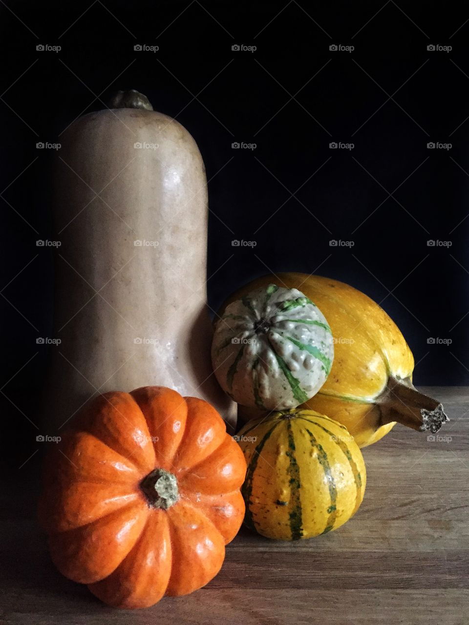 A selection of pumpkins, gourd and winter squash including butternut squash and a small pumpkin called a munchkin 