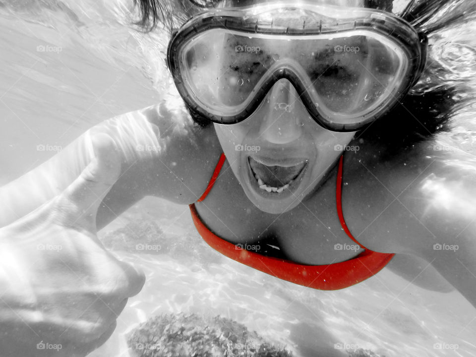 woman underwater. woman showing ok hand sign underwater,selective color