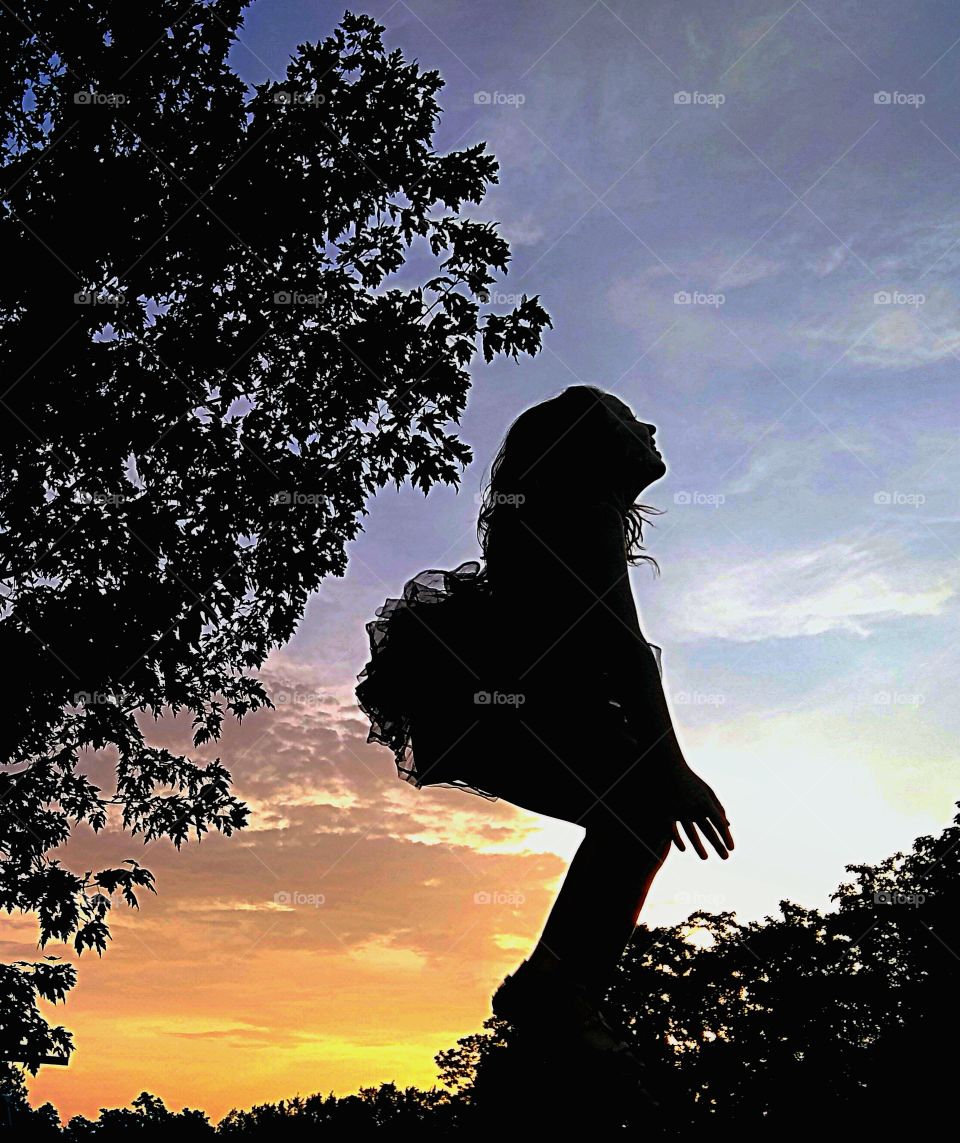 In her tutu, jumping on her trampoline,  precious 8-year-old Molly takes to the sky in another breath-taking sunset silhouette shot. I think, personally, she jumped into the shape of a heart in this photo (her head & tutu being the top🖤)