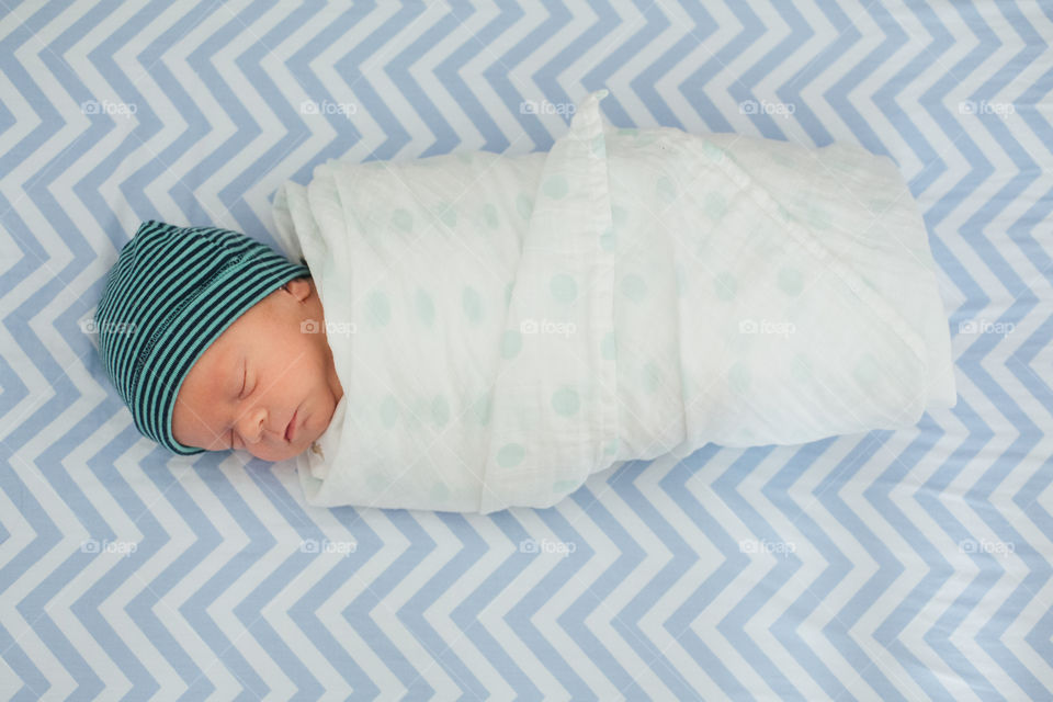 Newborn baby boy on blanket sleeping 