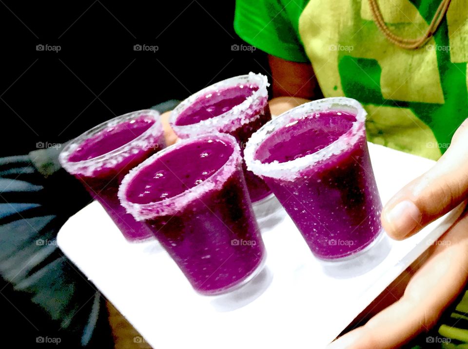 Grapes juice in glasses decorated with salt