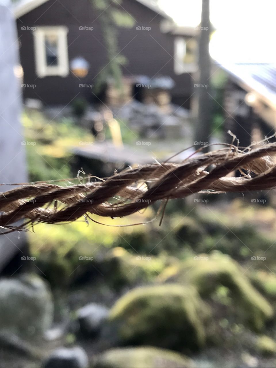 Plaited string with a cottage in the background 