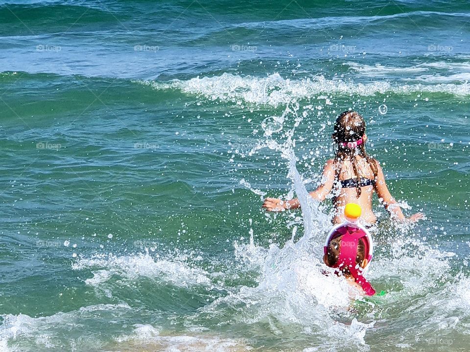 children playing in the ocean
