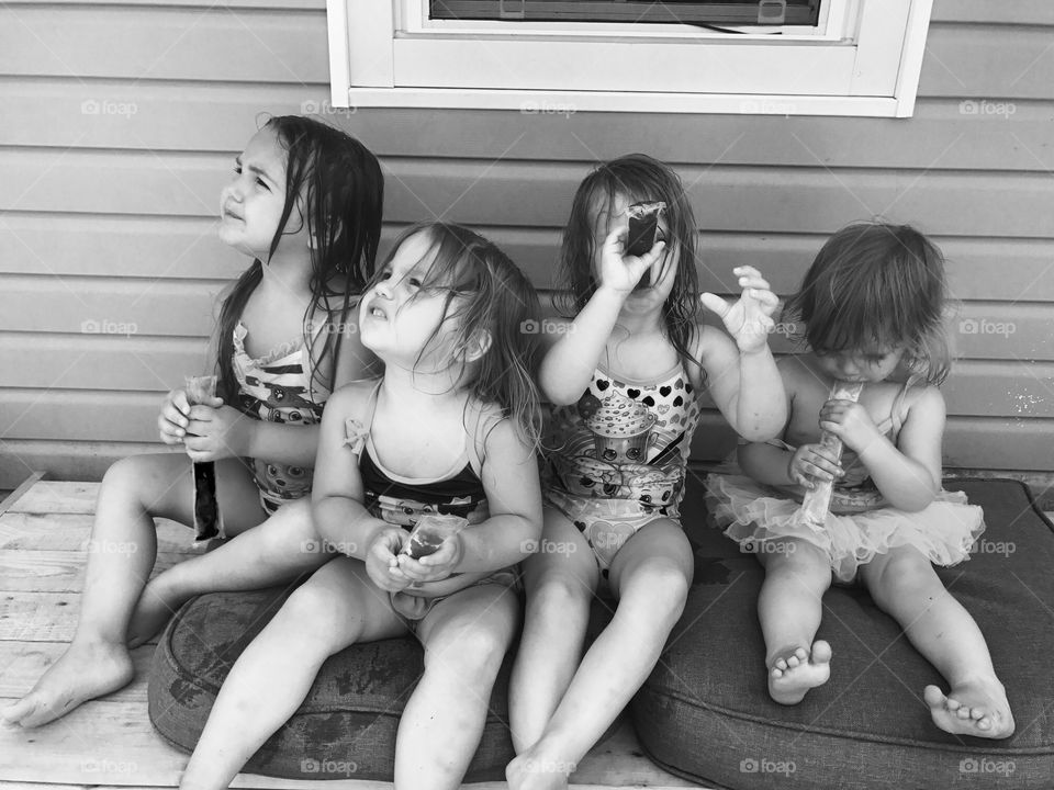 Group of small female children sitting with ice cream