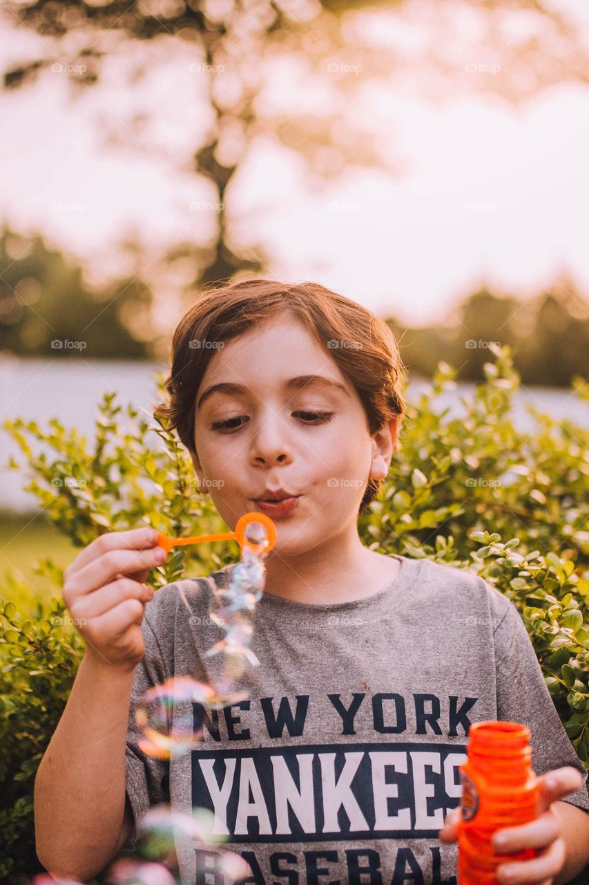 Boy blowing bubbles