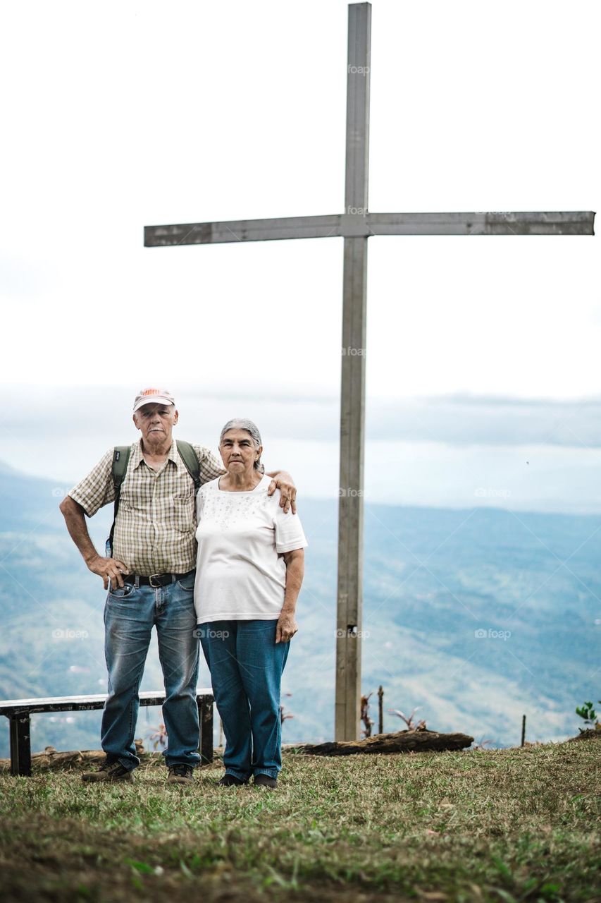 Elderly couple, enjoying a beautiful view on top of a mountain