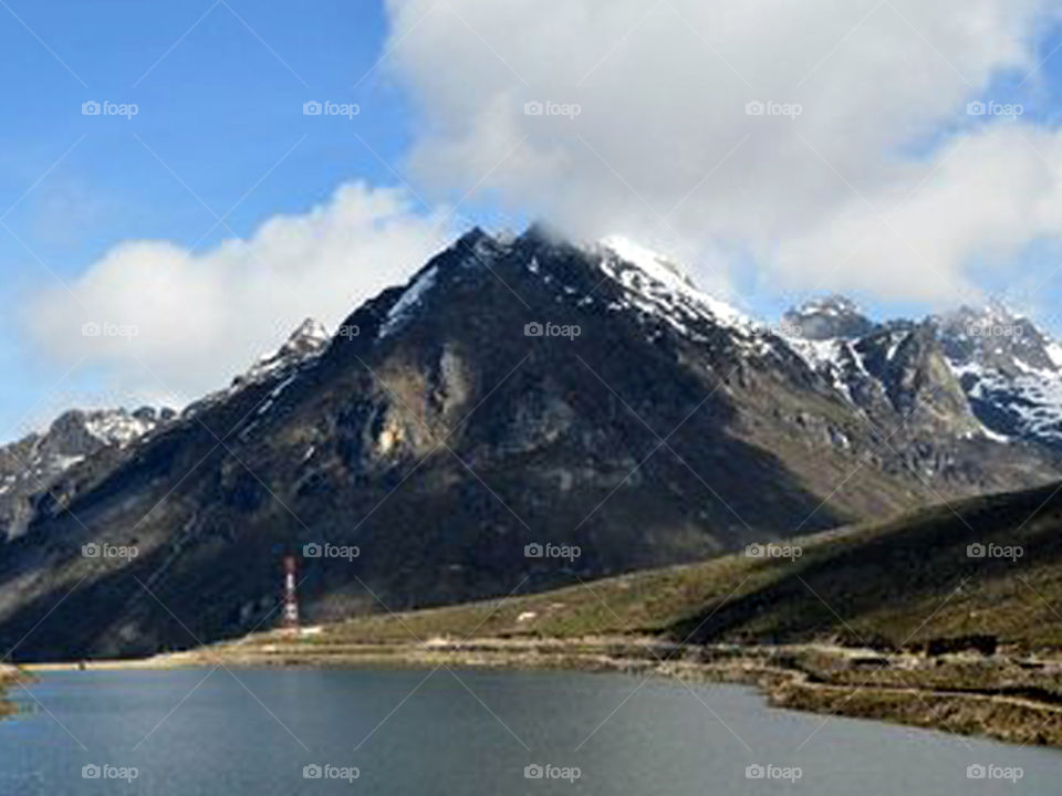 Arunachal Bomdila sela hill with blue sky white cloude n water lake.