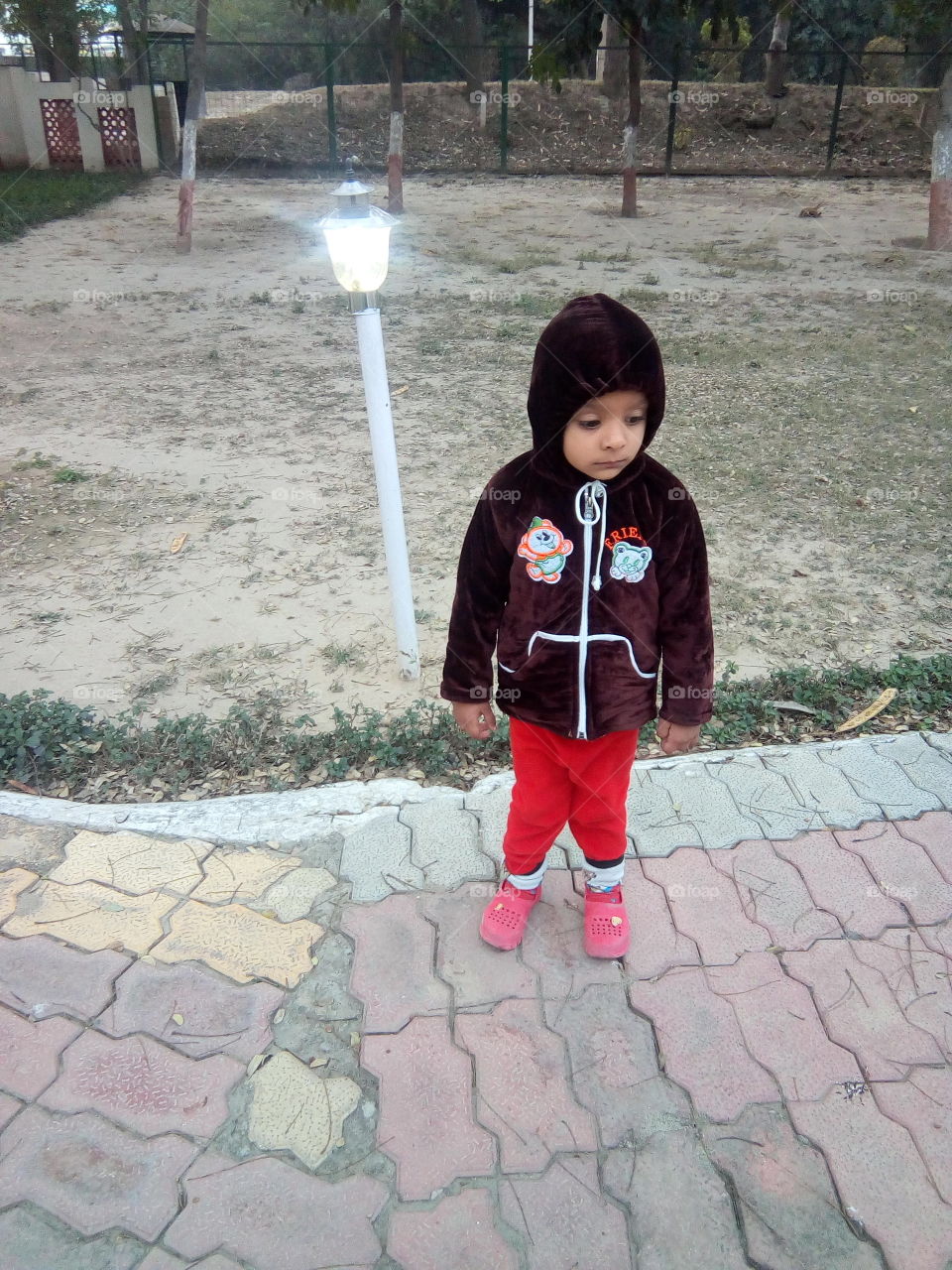 a cute little boy in a park.