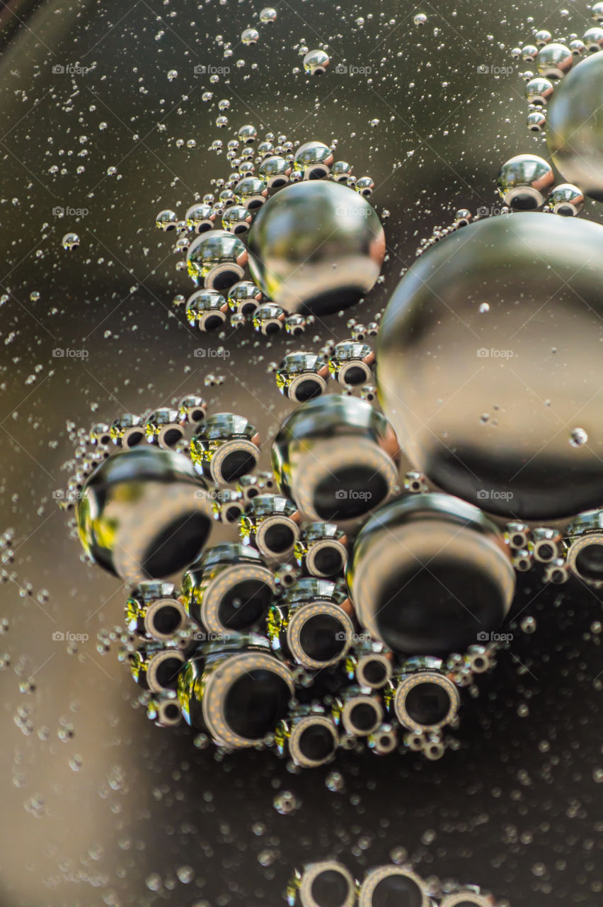 Small bubbles of vegetable oil in water close-up.