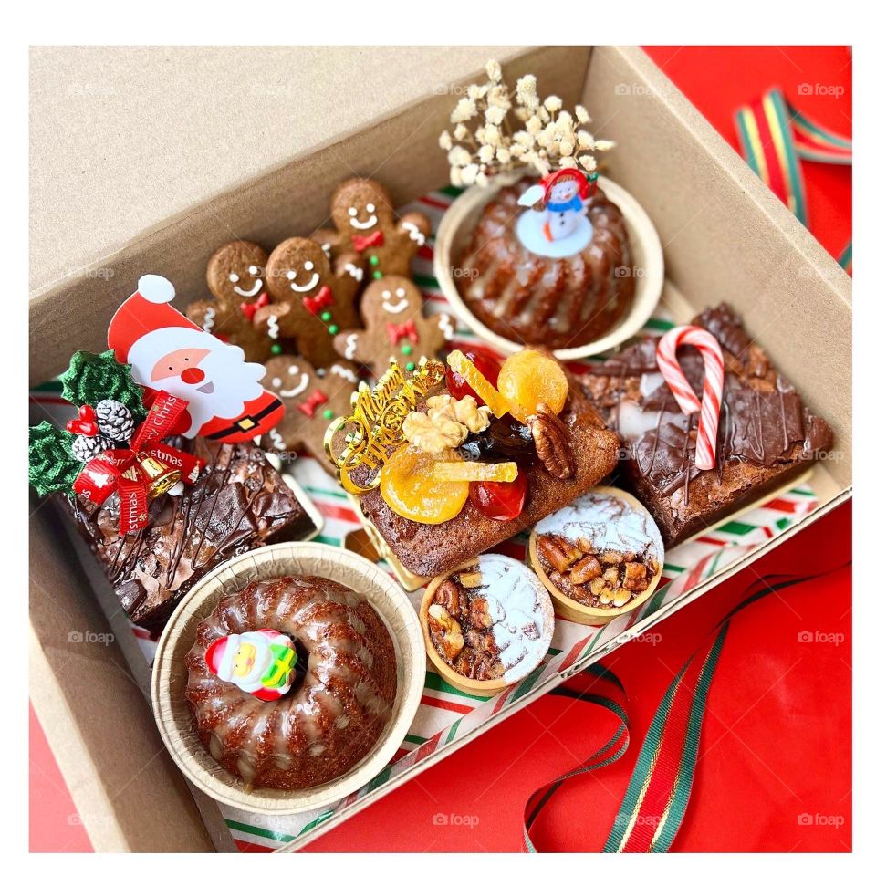 Christmas festive platter box with brownies , pudding tarts, pecan tarts and fruit cake.