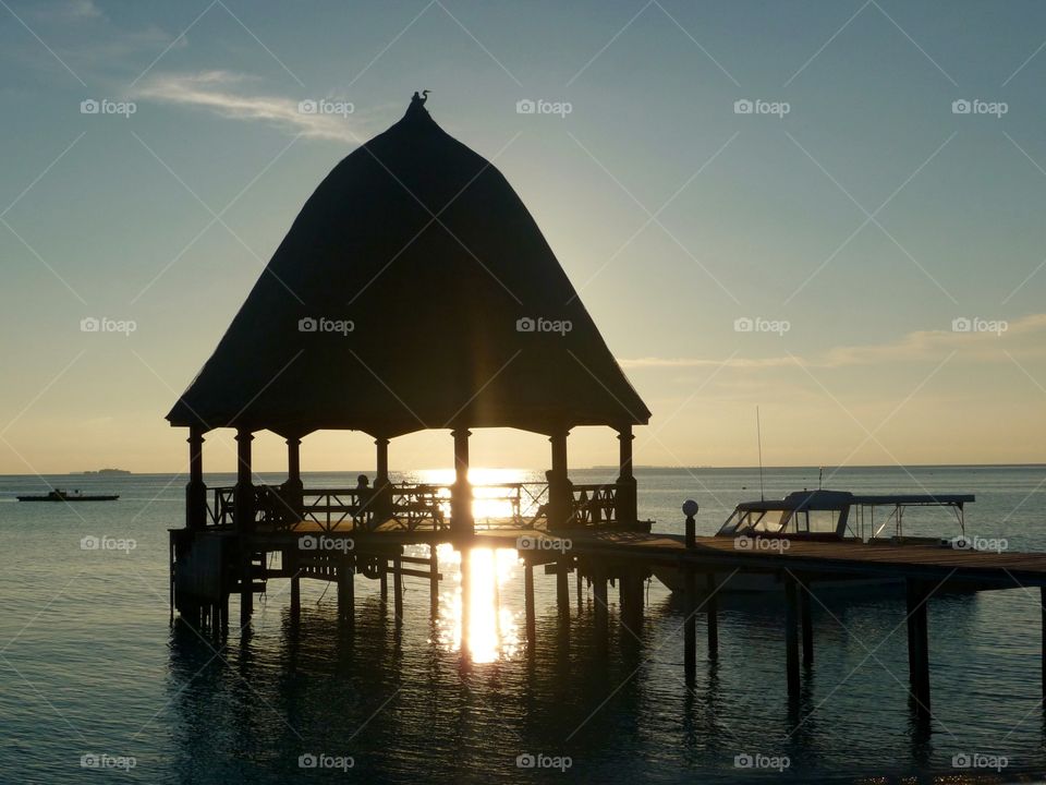 Golden Hour on Maldives Island. Sitting in the pavilion while enjoying the romantic atmosphere is amazing - the Maldives are a bucket list destination.
