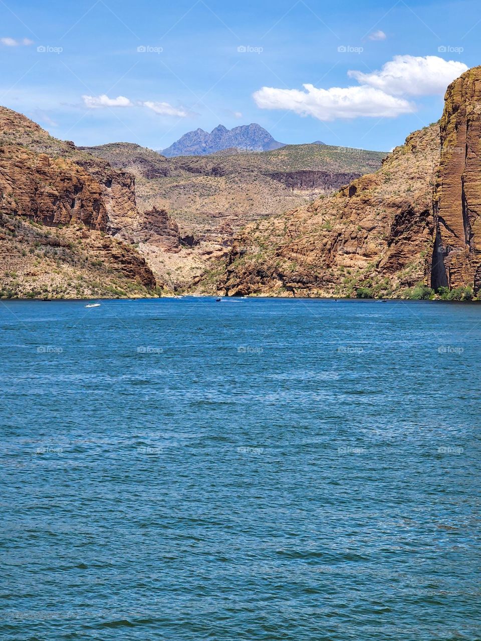 The rugged Four Peaks mountains loom in the background of a photo taken across the gorgeous Canyon Lake in Arizona