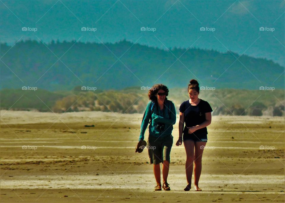 Two woman walking together at beach