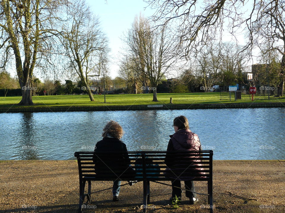 Ladies Chatting On A Park Bench - Autumn Time - Windy Weather
