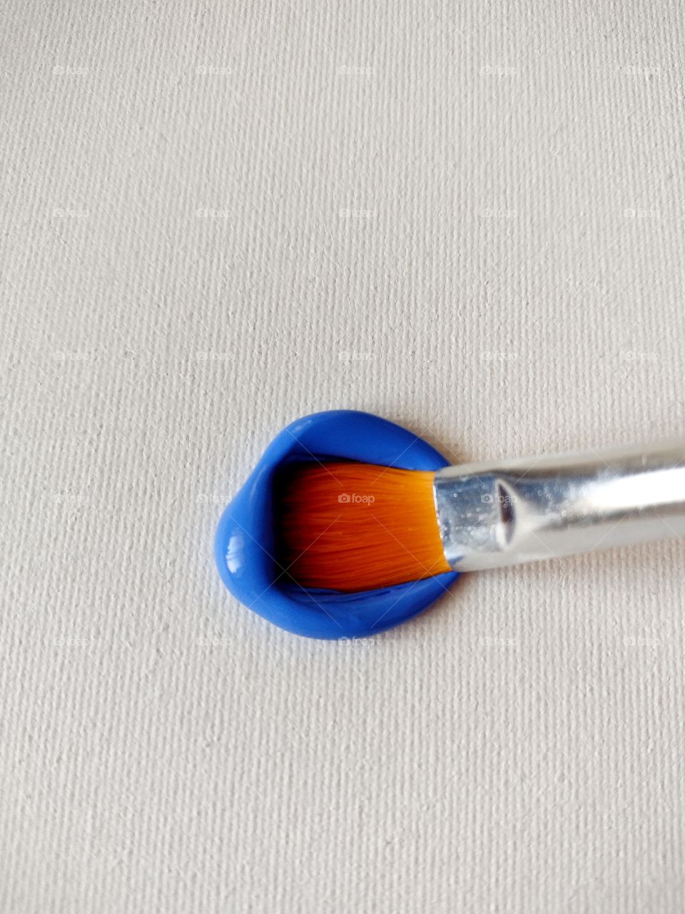 Unfiltered, beautiful, lovely close-up of blue paint and a paint brush