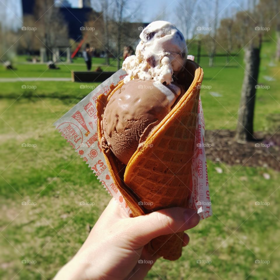 two flavors of ice cream in a waffle cone on a beautiful spring day bike ride
