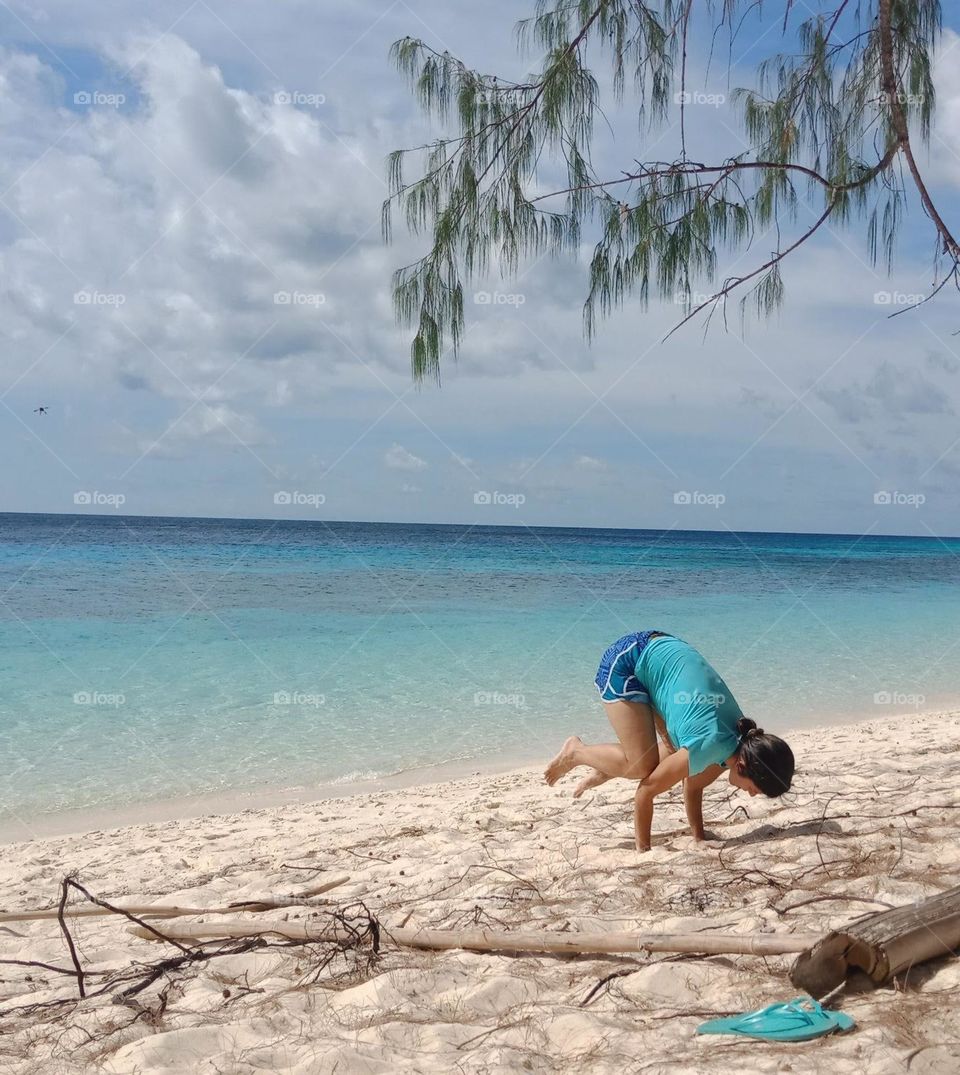 Frog pose at the beach