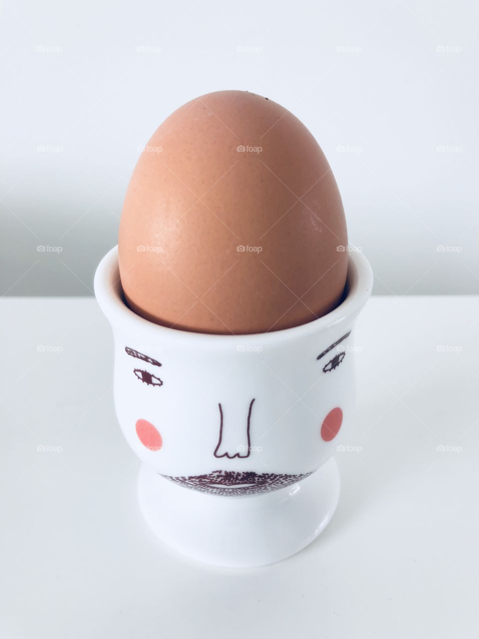 Easter Breakfast: Boiled egg in an hipster eggcup. Hipster with beard. 
