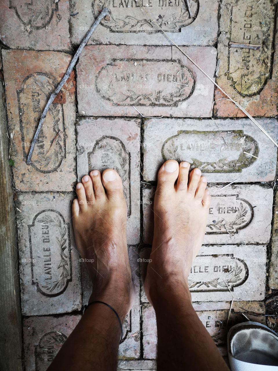 barefoot male on bricks