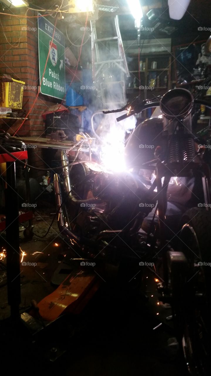 building a Harley Davidson . getting some welding done on the motorcycle