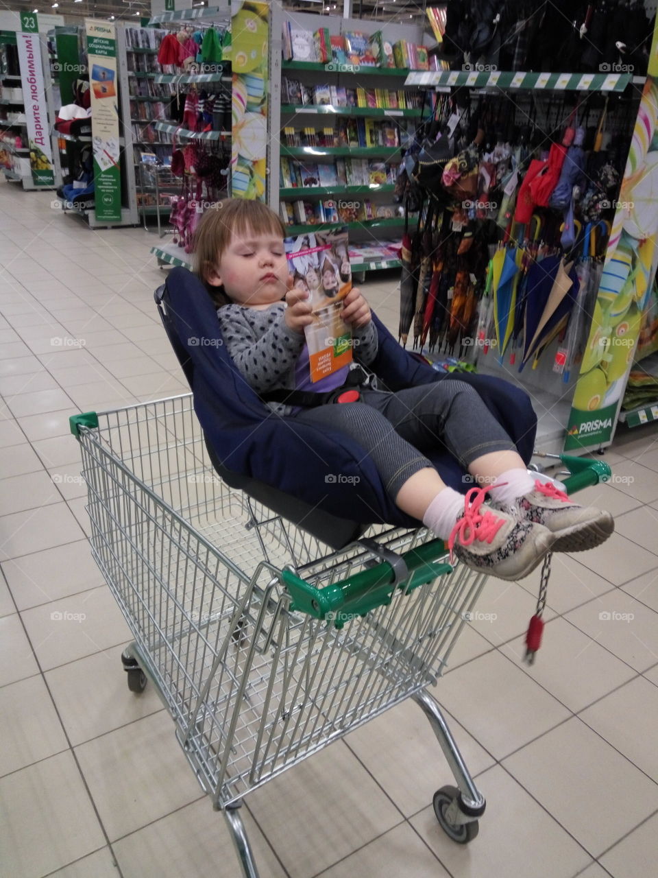 little girl sleeping in the shop trolley