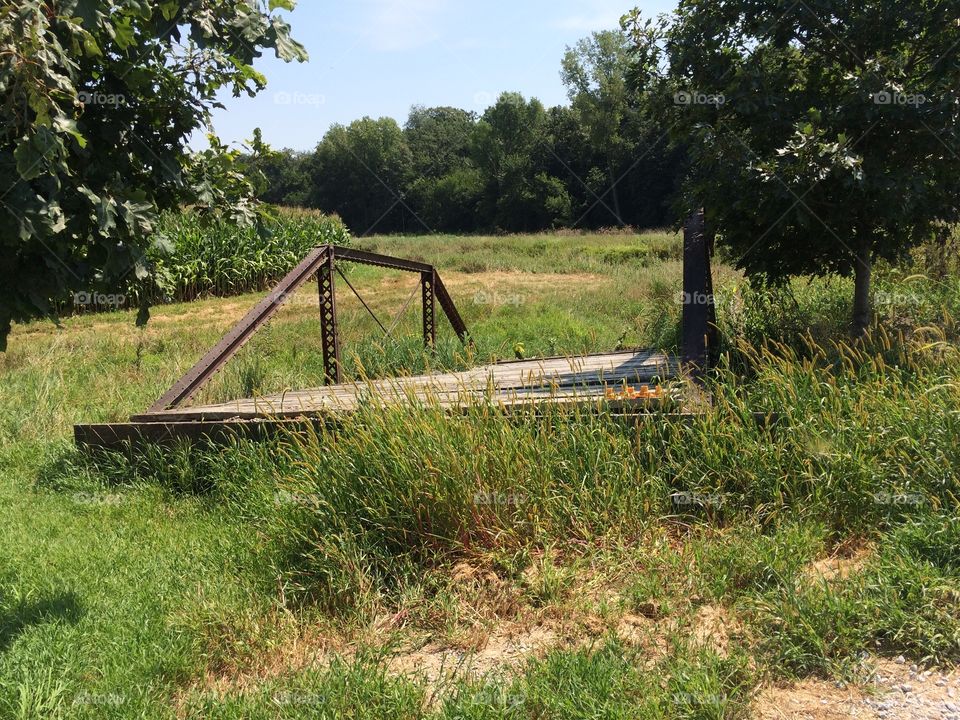Old pony truss bridge along side of the road. 
