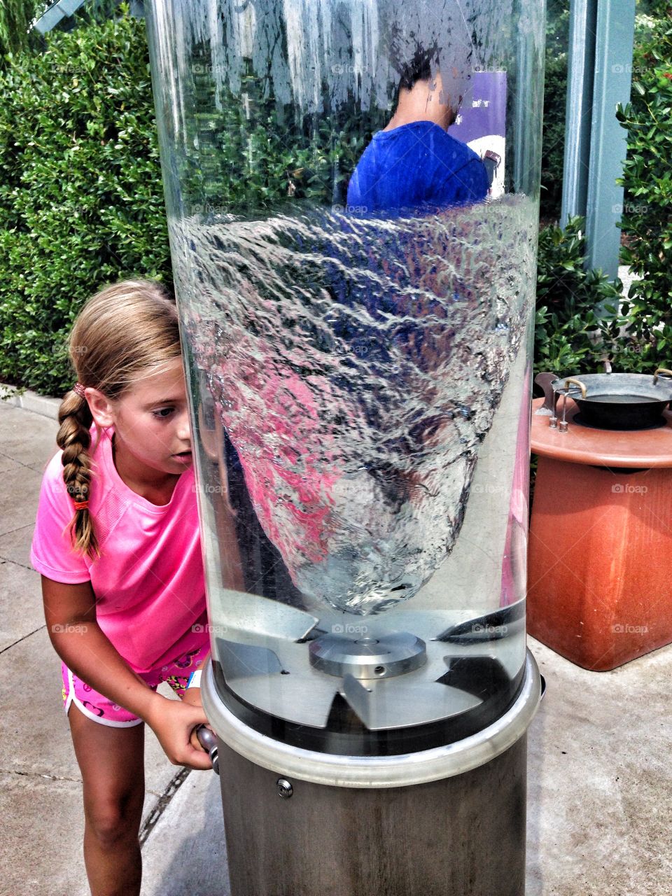 Water twister. Girl making a water twister in an outdoor exhibit