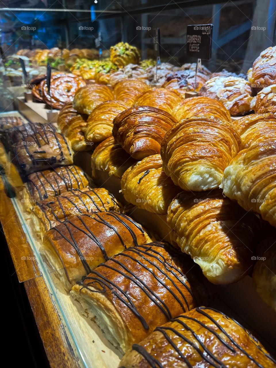 selling fresh breads and pastries from the oven. Stacks of various breads and pastries