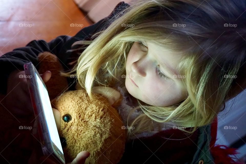 Cute little girl using smartphone