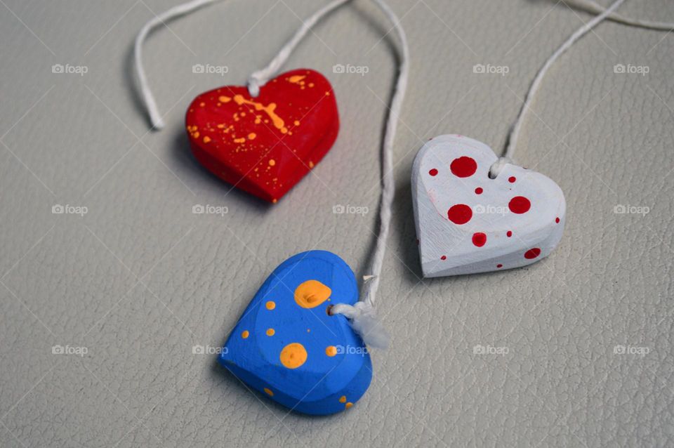 Multicolored wooden hearts on a thread