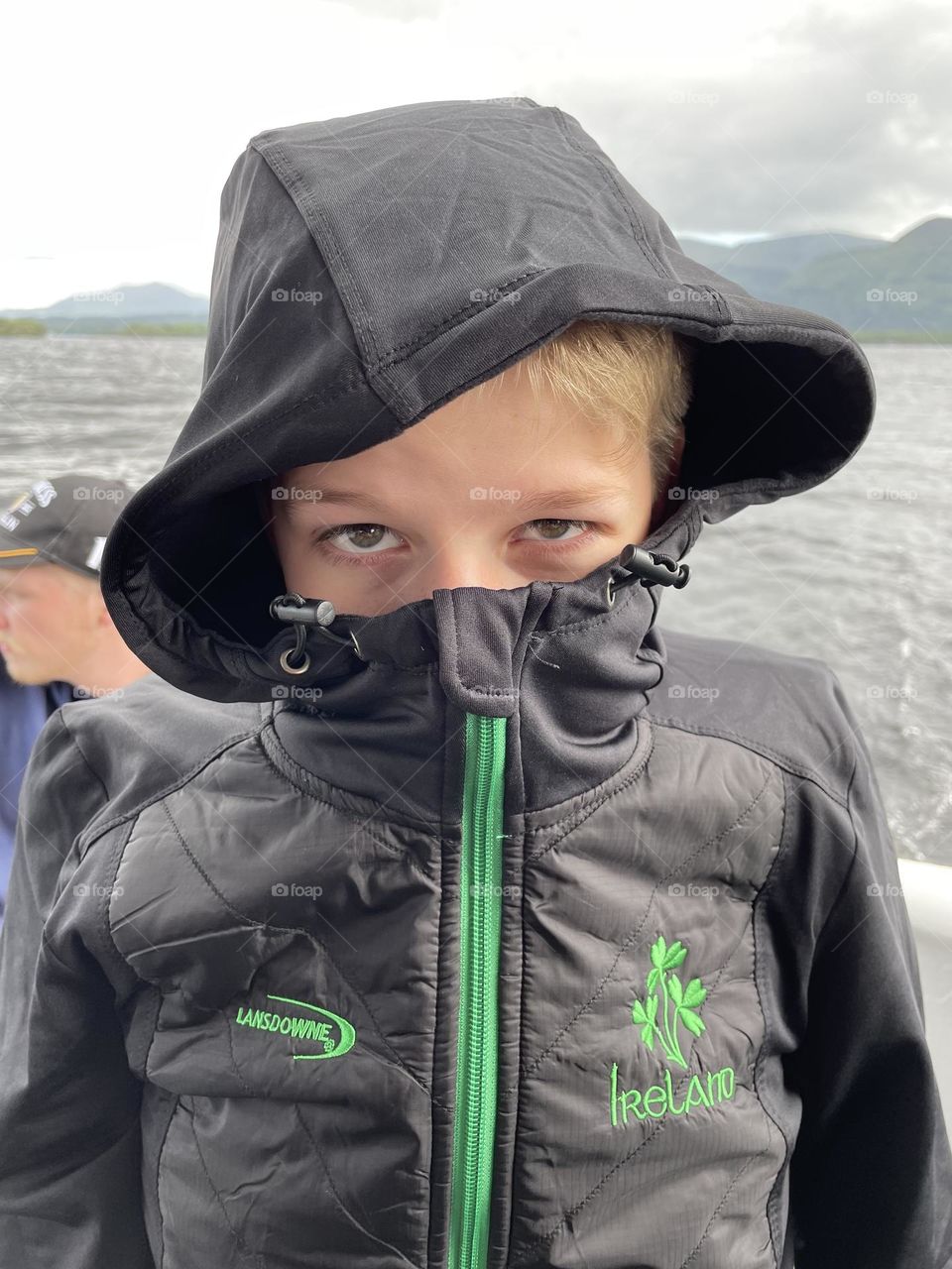 A windy day on Killarney Lake in Ireland prompts my a youngster to bundle up tight.