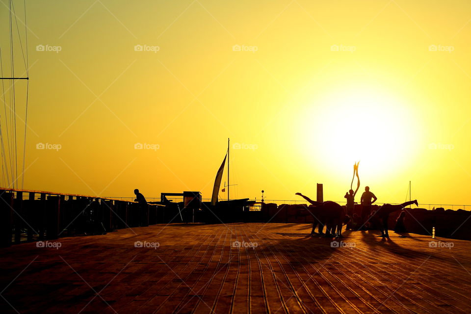 Women stretching near sailing boats