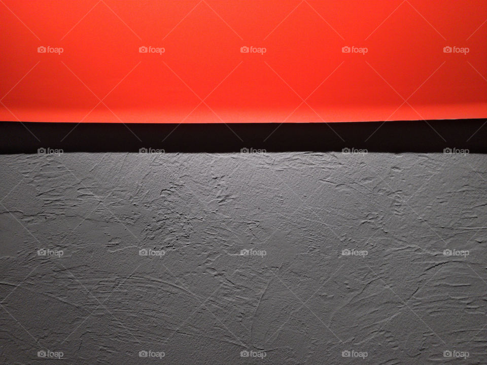 Orange minimalist poster detail over grey plastered background wall 04
