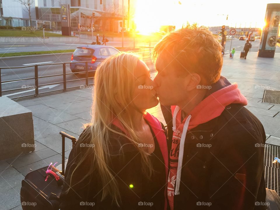 Couple kissing at the sunrise at Copenhagen Airport in Denmark.