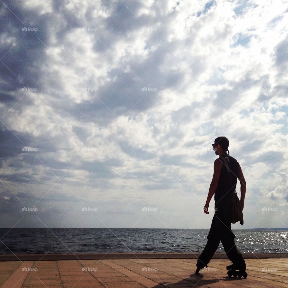 Young man standing against sea