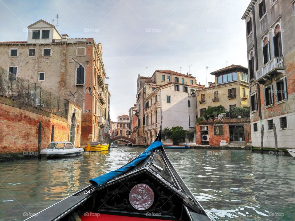 Venice, Italy. Canoe ride through one of the 150 canals of Venice in a sunny winter day.