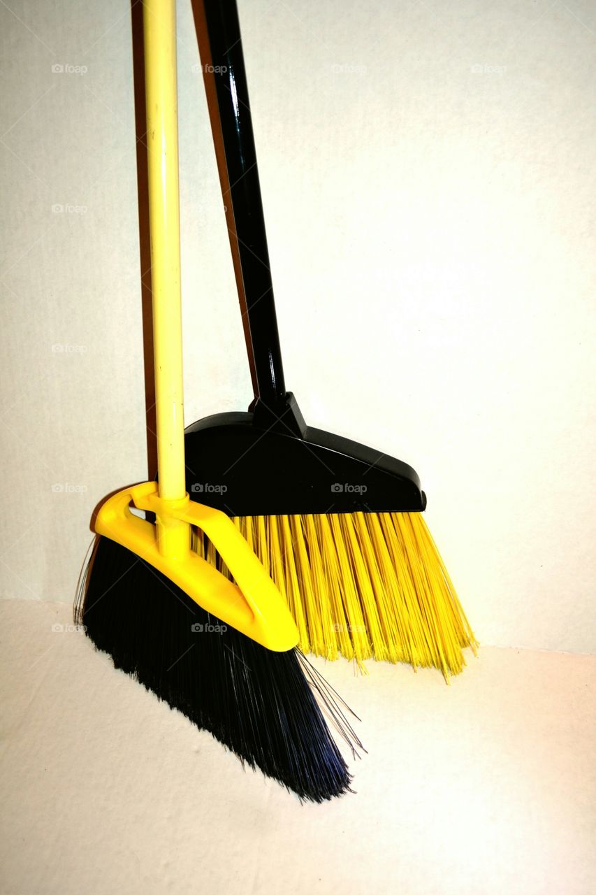 Two Yellow Brooms. Couple of bright yellow brooms  makes the chore of cleaning more cheerful.